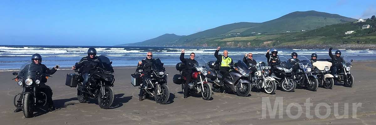 Motorradgruppe 10 motorradfreunde mit den Motorrädern auf dem Strand in
Irland während Motorradreise mit Motour